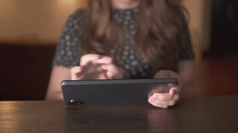 Unknown woman is using her tablet computer at home Stock Footage 321989241