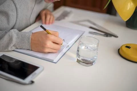 Unknown writes notes on Notepad Stock Photos
