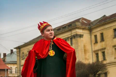 Unknown young actor in role king plays for the citizens in a Christmas perfor Stock Photos