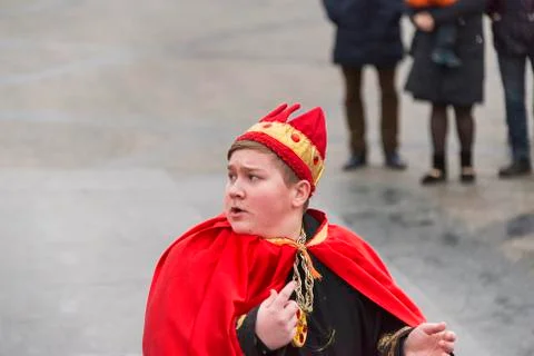 Unknown young actor in role king plays for the citizens in a Christmas perfor Stock Photos