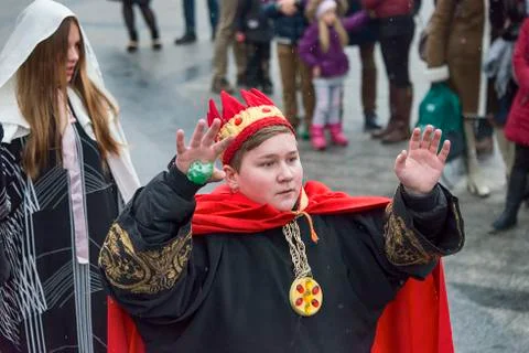 Unknown young actor in role king plays for the citizens in a Christmas perfor Stock Photos