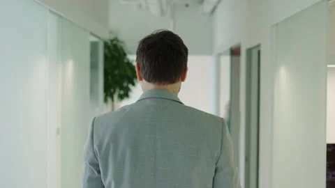 Unknown Young Businessman Walking Through Trendy Office. Stock Footage 244901908