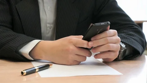 Unknown young man holding black smartphone Stock Footage 81310408