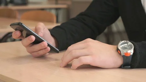 Unknown young man holding black smartphone Stock Footage 81311949