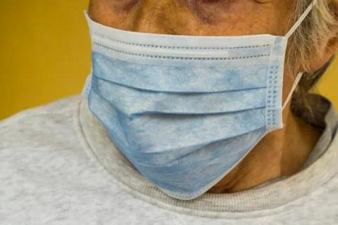 Unknown,old person is using single use hygenic face mask,close up Stock Photos