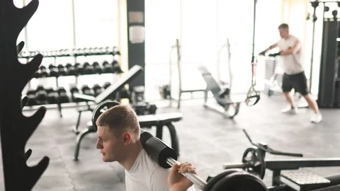 Unleash Your Potential Man Building Muscle with Barbell in Gym Training Stock Footage 323928905