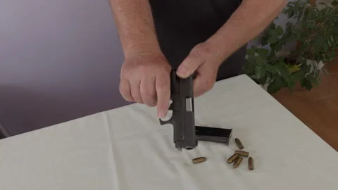 Unloading .45 ACP Pistol and Ejecting Chambered Round Stock Footage 337434474