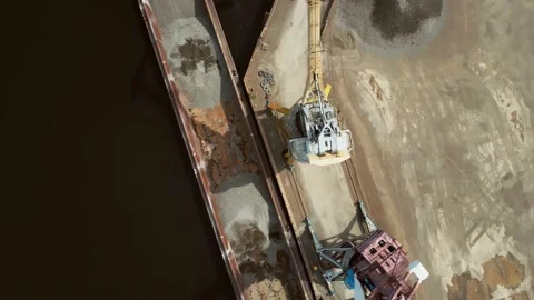 Unloading a barge at a river port. View from the drone. Stock Footage 154349371