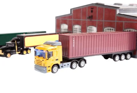 Unloading big container trucks at warehouse building 库存照片