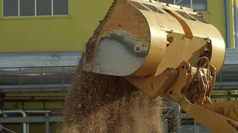 Unloading the bucket full of wood chips Stock Footage 71271008