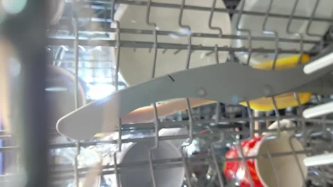 Unloading clean ceramic plates and glassware from kitchen dishwasher. Stock Footage 331335438