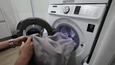 Unloading Clothes From Washing Machine. Taking  Clothes From Washing Machine Video stock 202075689