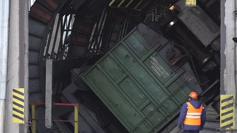 Unloading coal from a wagon. The car rolls up wheels Stock Footage 83798548