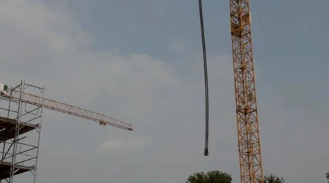 Unloading concrete slab by tower crane on residential building construction Stock Footage 40517226