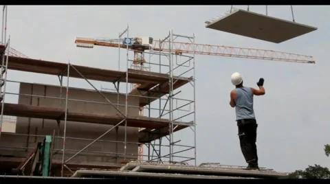 Unloading concrete slab by tower crane on residential building construction Stock Footage 40517681