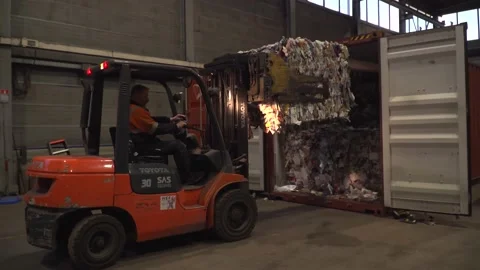 Unloading a container full of paper garbage waste wide shot 4K 動画素材 171943280