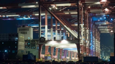 Unloading container to ship by industrial line gantry crane. 4K night time lapse Stock Footage 121993594