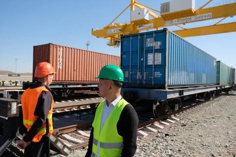 Unloading of containers at the station Stock Photos