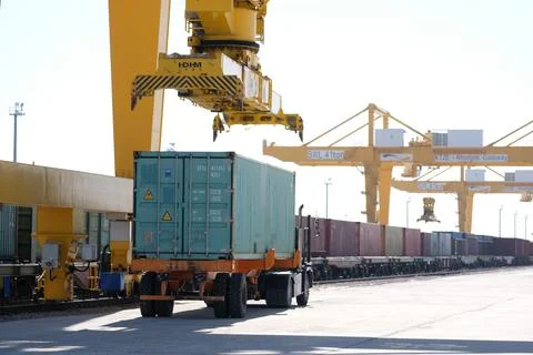 Unloading of containers at the station Stock Photos