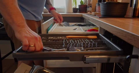 Unloading cutlery from the dishwasher Stock Footage 264584995