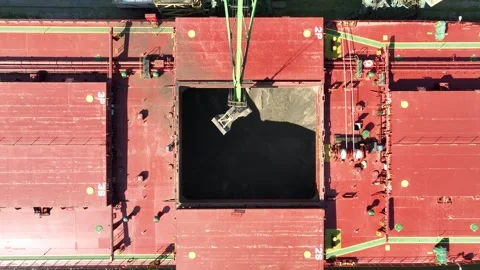 Unloading dry cargo ship of wheat by cranes in port. Stock Footage 335618263