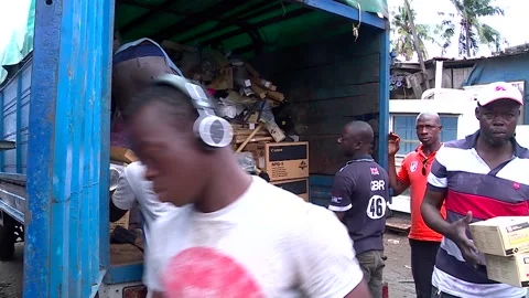 Unloading of electronic waste (E-Waste) from a container in Abidjan. Africa Stock Footage 138877456