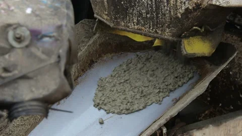 Unloading of fresh cement mixture from the mixer truck into the concrete sprayer Stock Footage 98572643