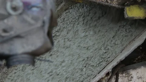 Unloading of fresh cement mixture from the mixer truck into the concrete sprayer Stock Footage 98572904