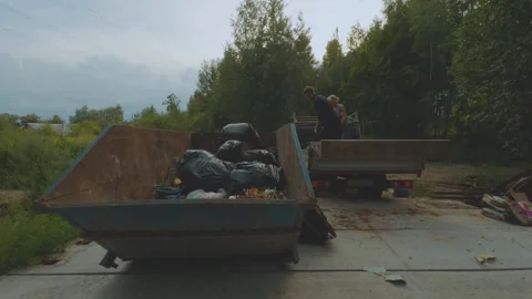 Unloading garbage, unloading garbage from the car Stock Footage 321878703