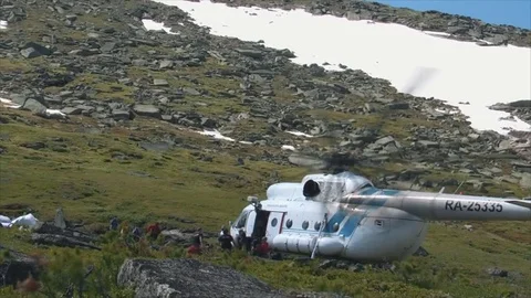 Unloading helicopter in a mountain gorge Stock-Footage 83697602