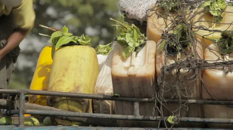 Unloading jerrycans Stockbeeldmateriaal 64306408