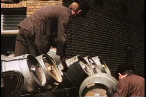 Unloading kegs from beer wagon, medium shot, London, England, 1970's Stock Footage