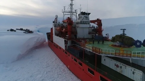Unloading of large cargoes from a ship in Antarctica Stock Footage 119570513