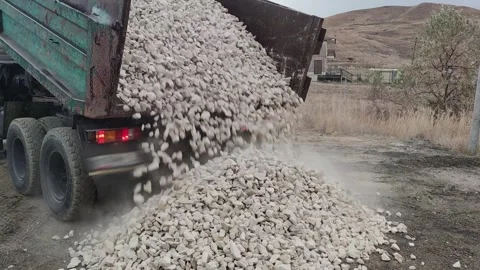 Unloading a large quantity of gravel from a dump truck 動画素材 261964653