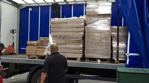 Unloading a lorry carrying heavy packages. Stock Footage 158908915