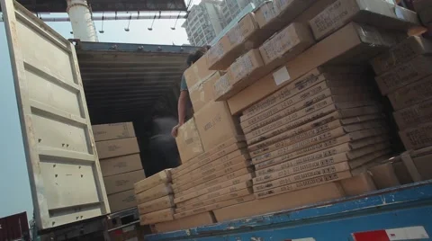 Unloading of the moving van and loading of the container wagon a cardboard box Stock Footage 59157994