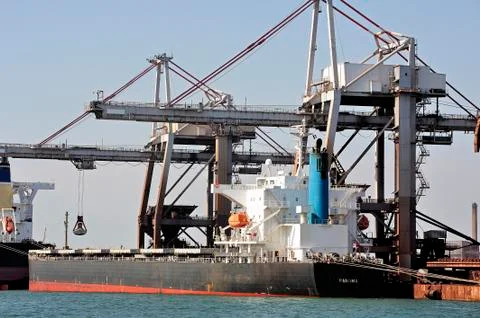 Unloading of an ore cargo liner Stock Photos
