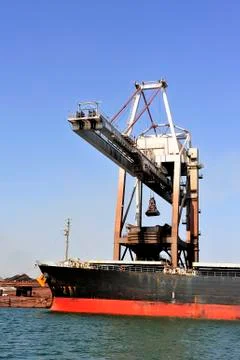 Unloading of an ore cargo liner Stock Photos
