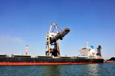 Unloading of an ore cargo liner Stock Photos