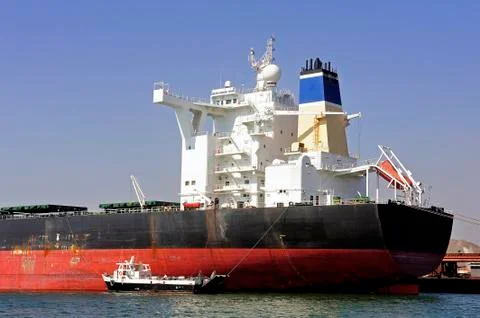 Unloading of an ore cargo liner Stock Photos
