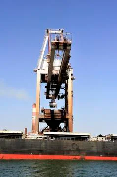 Unloading of an ore cargo liner Stock Photos
