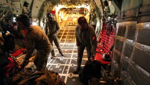 Unloading parachute packs on C-130  (HD) c Stockbeeldmateriaal 8550980