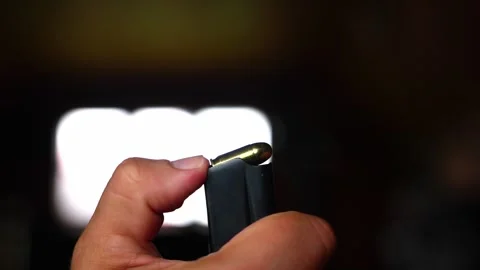 Unloading pistol magazine Stock Footage 313654542