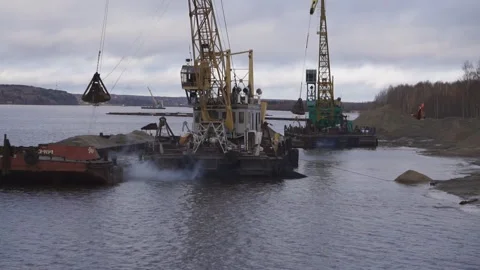 Unloading of sand barge on shore of river at spring day. Video stock 86052860