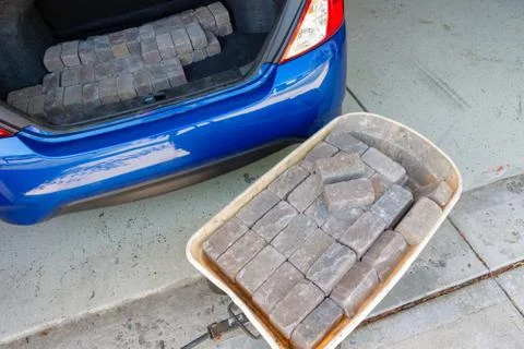 Unloading stacked grey bricks from the car Stock Photos