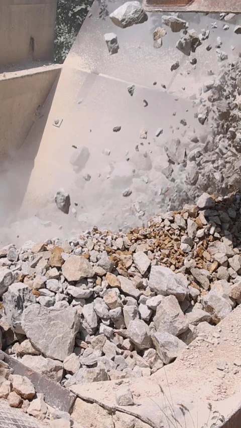 Unloading of stone from the truck to the crusher at open pit mining, slow motion Stock Footage 341512678