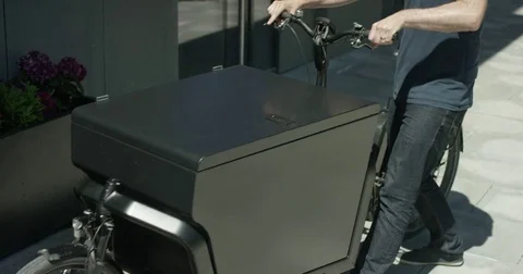 Unloading a toolbox out of  a courier bicycle Stock Footage 77550239