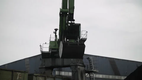 Unloading wagon with coal using port crane. Stage of transportation of raw Stock Footage 205238991