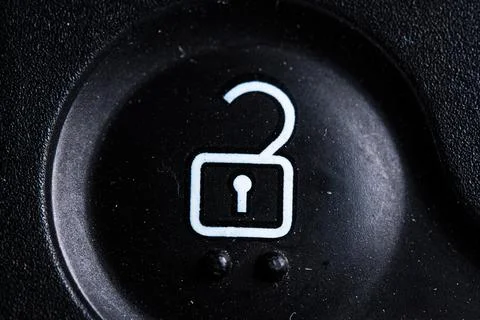 The unlock icon button is close on the digital car key device. Old and dirty Stock Photos
