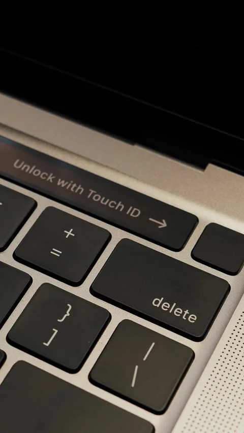 Unlock with Touch ID sensor on laptop computer. Vertical video Stock Footage 311258157